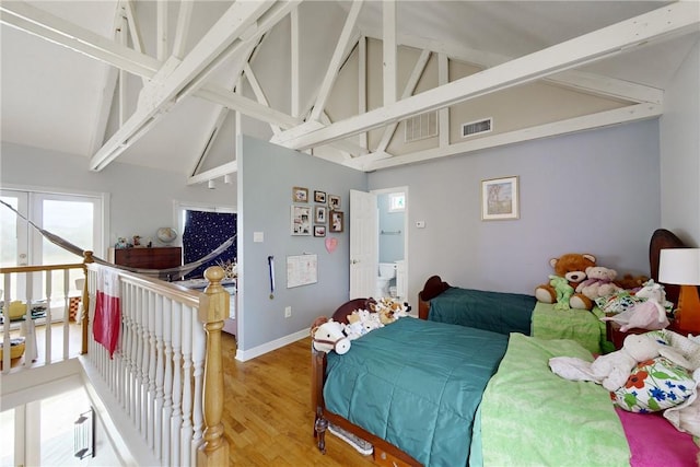 bedroom featuring high vaulted ceiling, wood-type flooring, and beamed ceiling