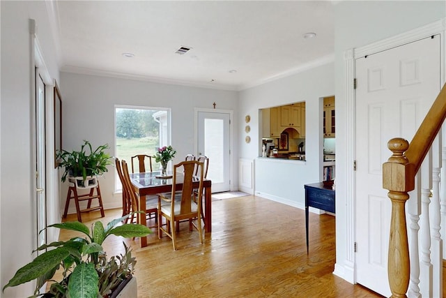 dining room featuring light hardwood / wood-style floors and ornamental molding