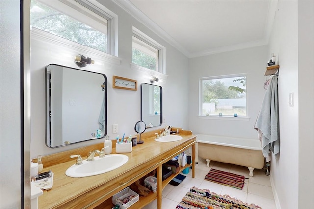 bathroom with a bath, vanity, tile patterned flooring, and ornamental molding