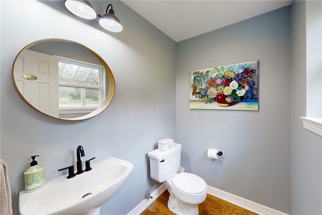 bathroom with sink, toilet, and hardwood / wood-style flooring