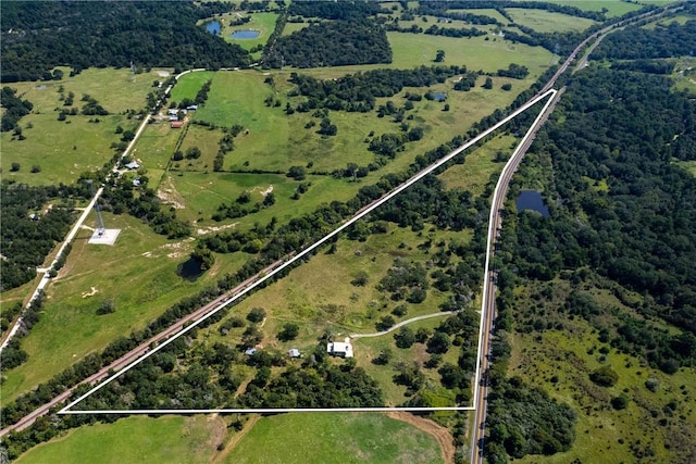 drone / aerial view featuring a water view and a rural view