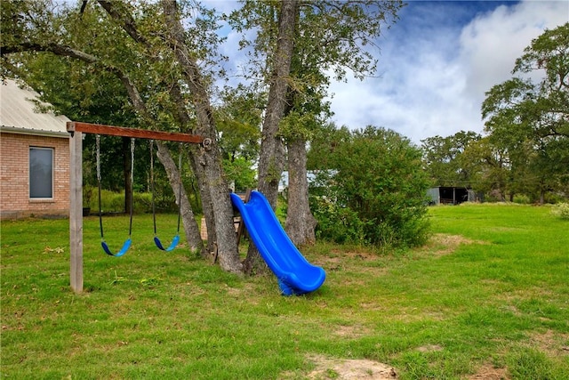 view of playground with a lawn