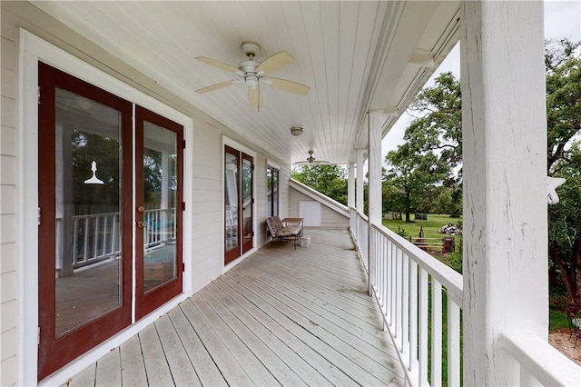 wooden terrace featuring ceiling fan and a porch