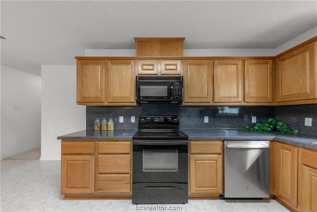 kitchen with black appliances, dark stone countertops, and tasteful backsplash