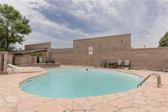 view of swimming pool featuring a patio area