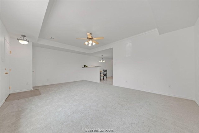 spare room with light carpet, ceiling fan, and crown molding