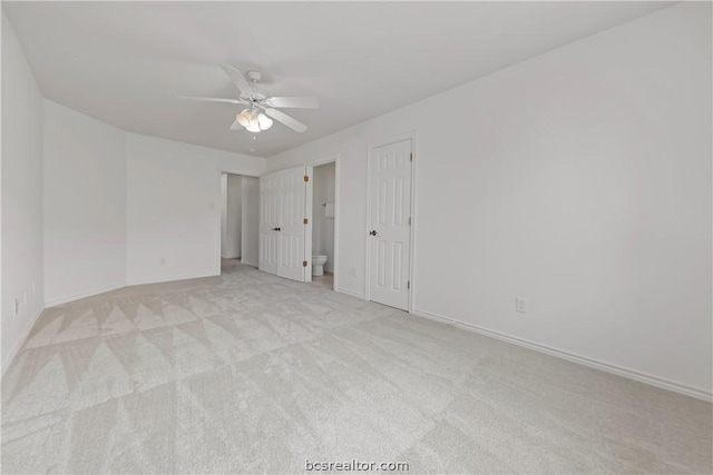 empty room with ceiling fan and light colored carpet