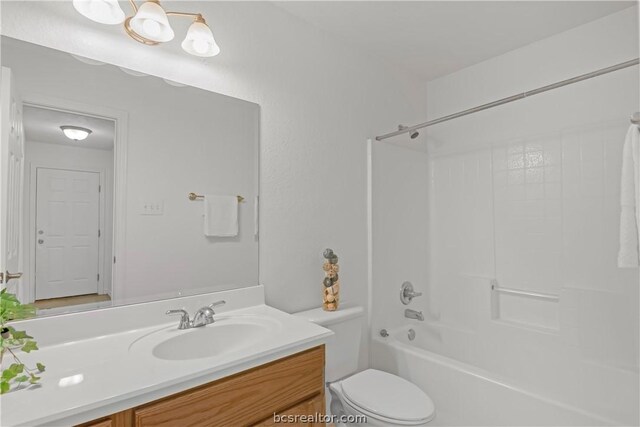 full bathroom featuring shower / bathing tub combination, vanity, and toilet