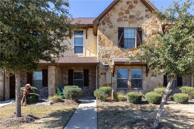 view of front of property featuring stone siding and brick siding