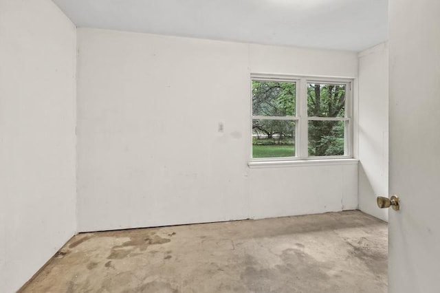 unfurnished room with unfinished concrete floors
