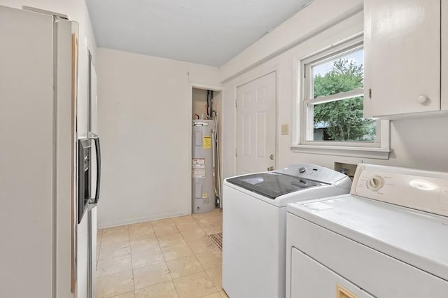 laundry area featuring washing machine and dryer, water heater, and cabinet space