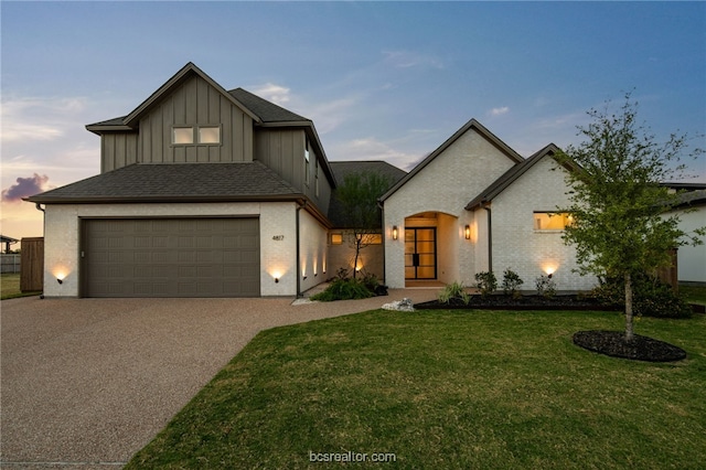 view of front of house featuring a lawn and a garage