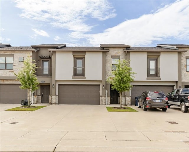 515 Hayes Ln, College Station, TX 77845 - view of front of home with a garage, stucco siding, stone siding, and concrete driveway