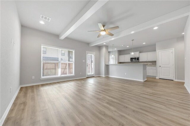 515 Hayes Ln, College Station, TX 77845 - unfurnished living room featuring a ceiling fan, beam ceiling, light wood finished floors, and recessed lighting