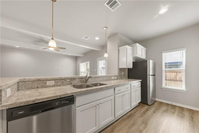 515 Hayes Ln, College Station, TX 77845 - kitchen featuring appliances with stainless steel finishes, white cabinets, light stone counters, light wood finished floors, and ceiling fan