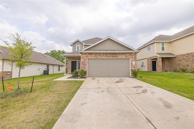 975 Harper Ln, Bryan, TX 77803 - view of front of property featuring a garage, driveway, a front lawn, and brick siding