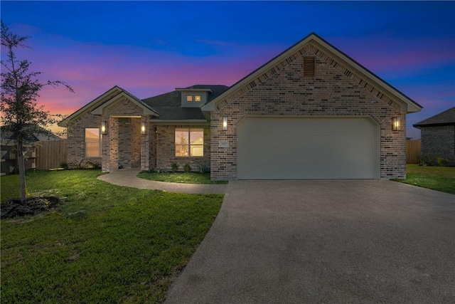 view of front of home featuring a garage and a yard