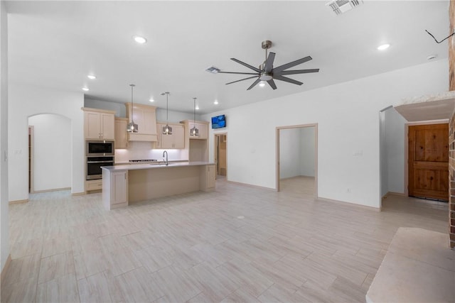 2917 Bombay Ct, Bryan, TX 77808 - kitchen featuring appliances with stainless steel finishes, open floor plan, ceiling fan, an island with sink, and recessed lighting