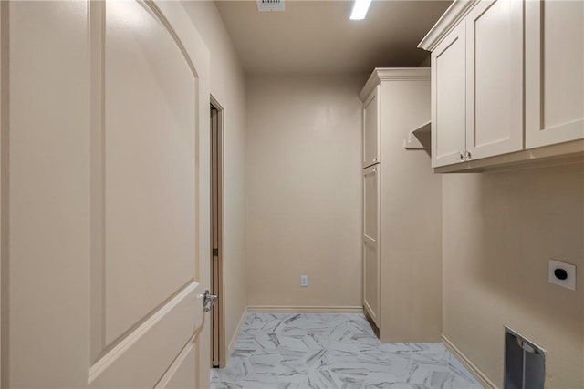 2917 Bombay Ct, Bryan, TX 77808 - laundry room with hookup for an electric dryer, cabinet space, and light marble finish flooring