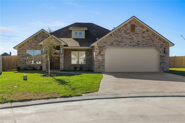 view of front of house featuring a garage and a front yard