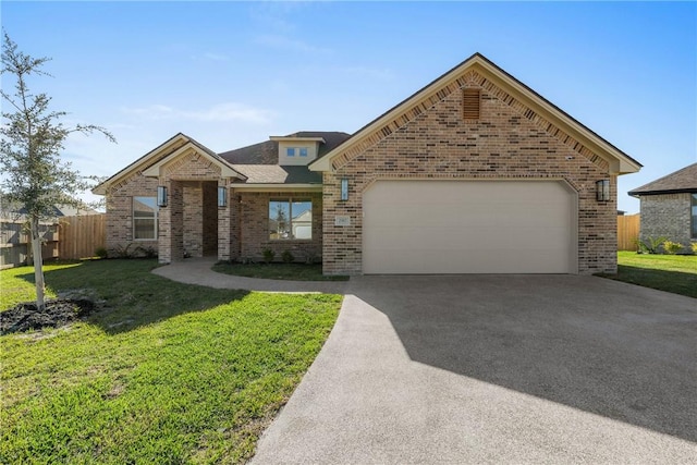 view of front facade with a front yard and a garage