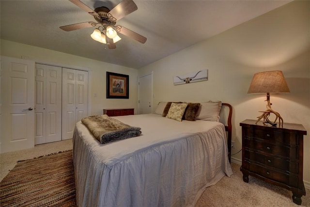 carpeted bedroom with ceiling fan and a closet