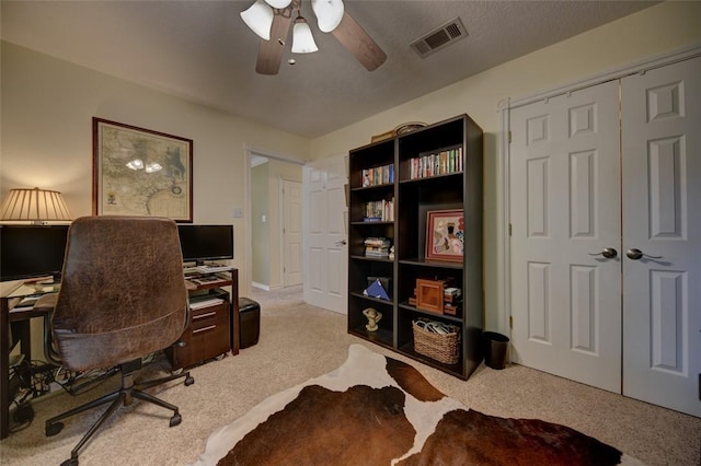 carpeted office featuring ceiling fan