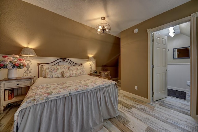 bedroom featuring a textured ceiling and light hardwood / wood-style floors