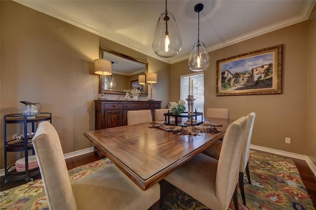 dining area with hardwood / wood-style flooring and ornamental molding