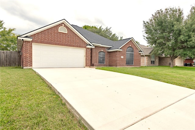 ranch-style house with a garage and a front lawn