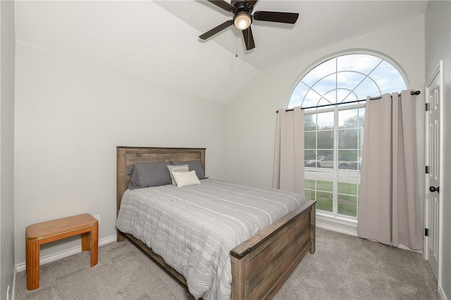 carpeted bedroom with ceiling fan and vaulted ceiling