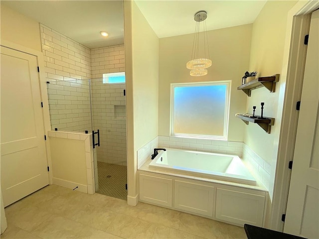 bathroom featuring independent shower and bath