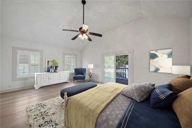 bedroom with hardwood / wood-style floors, ceiling fan, access to exterior, and high vaulted ceiling