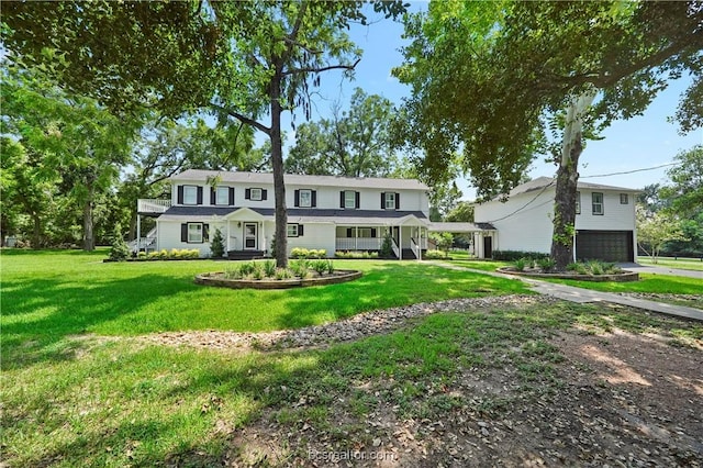 view of front of property featuring a garage and a front yard