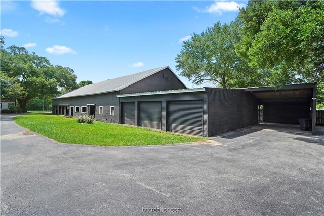 exterior space featuring a carport and a yard