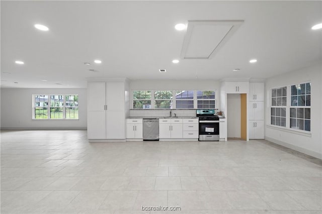 kitchen featuring white cabinets, stainless steel appliances, plenty of natural light, and sink