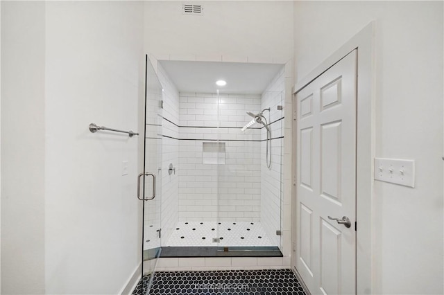 bathroom with tile patterned floors and walk in shower