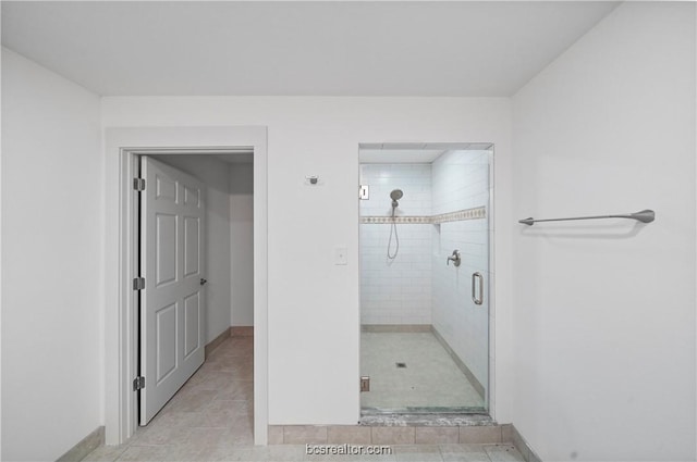 bathroom with tile patterned floors and walk in shower