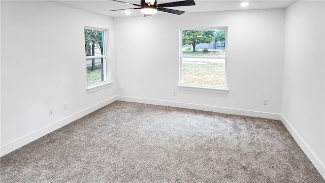 spare room with carpet flooring, baseboards, a healthy amount of sunlight, and a ceiling fan