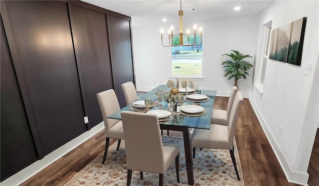 dining space featuring wood finished floors, visible vents, baseboards, recessed lighting, and a notable chandelier