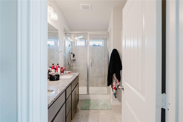 2140 Chief St, Bryan, TX 77807 - full bathroom featuring a stall shower, double vanity, and tile patterned flooring