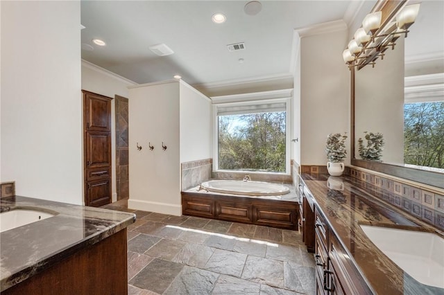 full bath with double vanity, plenty of natural light, crown molding, and stone tile flooring