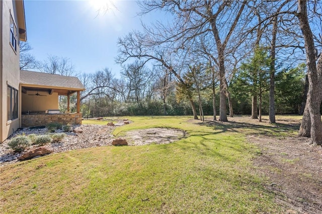 view of yard featuring a ceiling fan