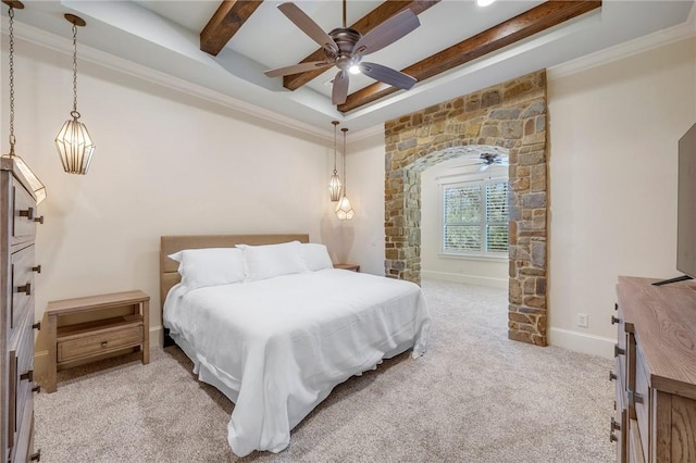 bedroom with a tray ceiling, light colored carpet, ornamental molding, beamed ceiling, and baseboards