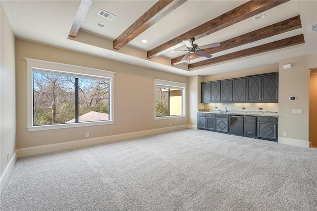 unfurnished living room featuring baseboards, visible vents, beam ceiling, carpet floors, and indoor wet bar