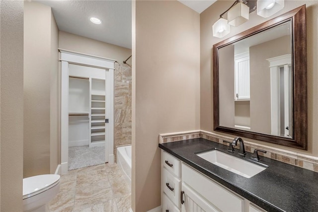 full bath with vanity, toilet, and baseboards