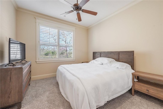 bedroom featuring a ceiling fan, baseboards, crown molding, and light colored carpet