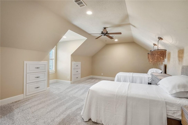 bedroom featuring vaulted ceiling, light carpet, visible vents, and baseboards