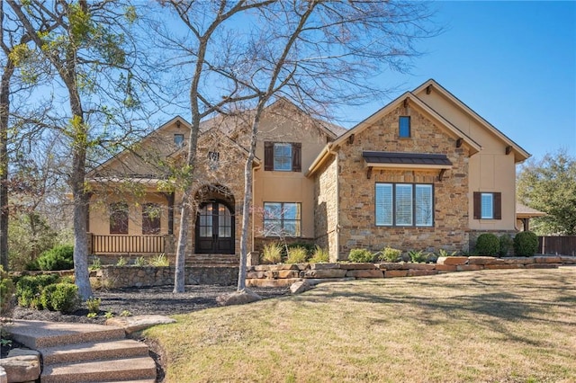 view of front of home with stone siding and a front yard