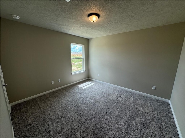 unfurnished room featuring carpet floors and a textured ceiling